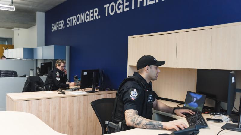 two officers sitting at their desks 