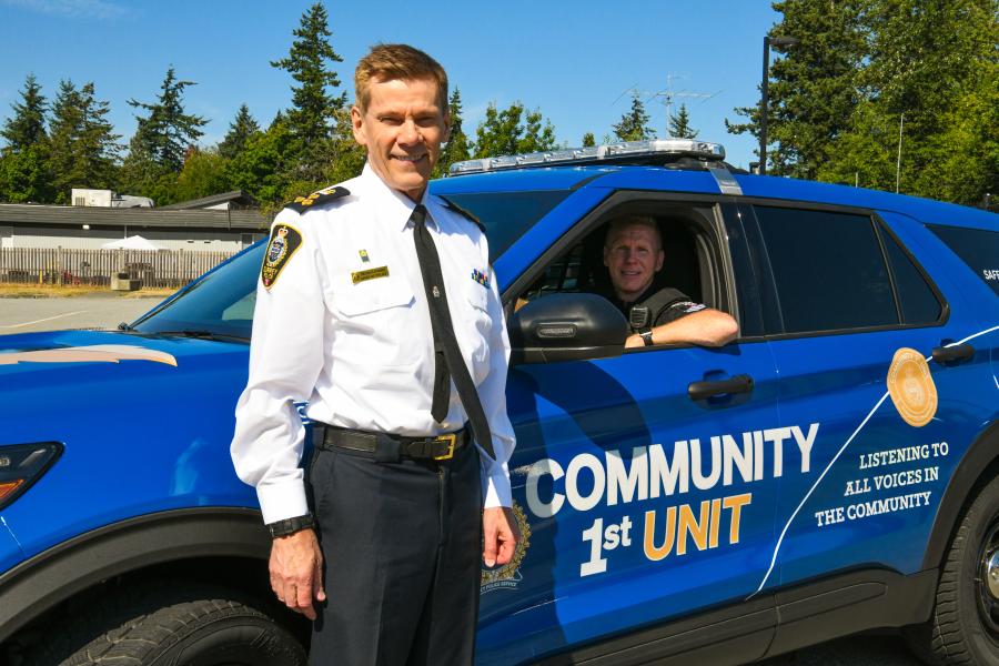 Chief standing in front of Community First vehicle 
