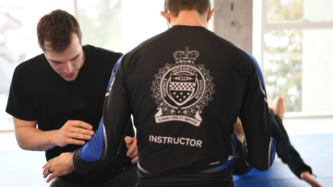 Gracie Survival Tactics Instructor with student on mat