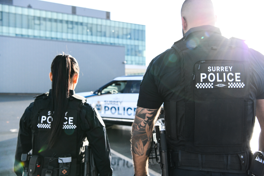 Jas and Madison walking towards police vehicle 