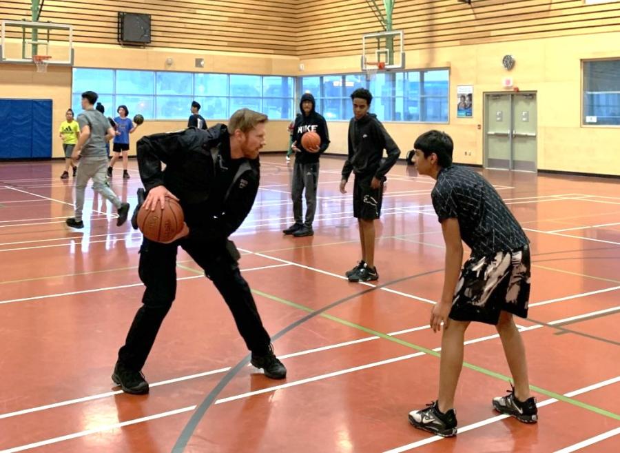 Officers playing basketball with youth