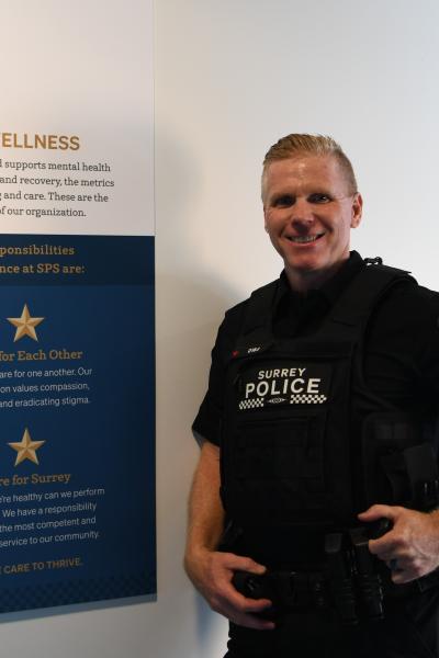 Dale standing in front of Wellness sign